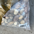 Bag of stones with a visible brand name on a concrete surface