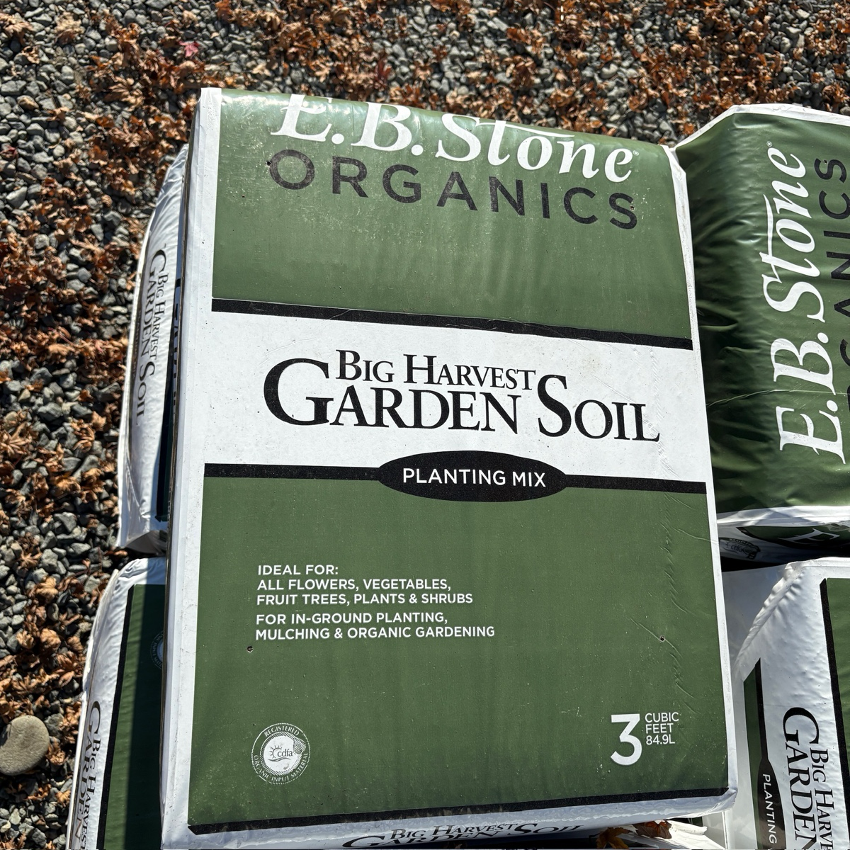 Bag of E.B. Stone Organics Big Harvest Garden Soil on a gravel background