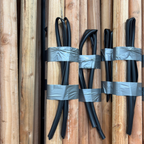 Black cables wrapped with duct tape on a Wood Planting Poles