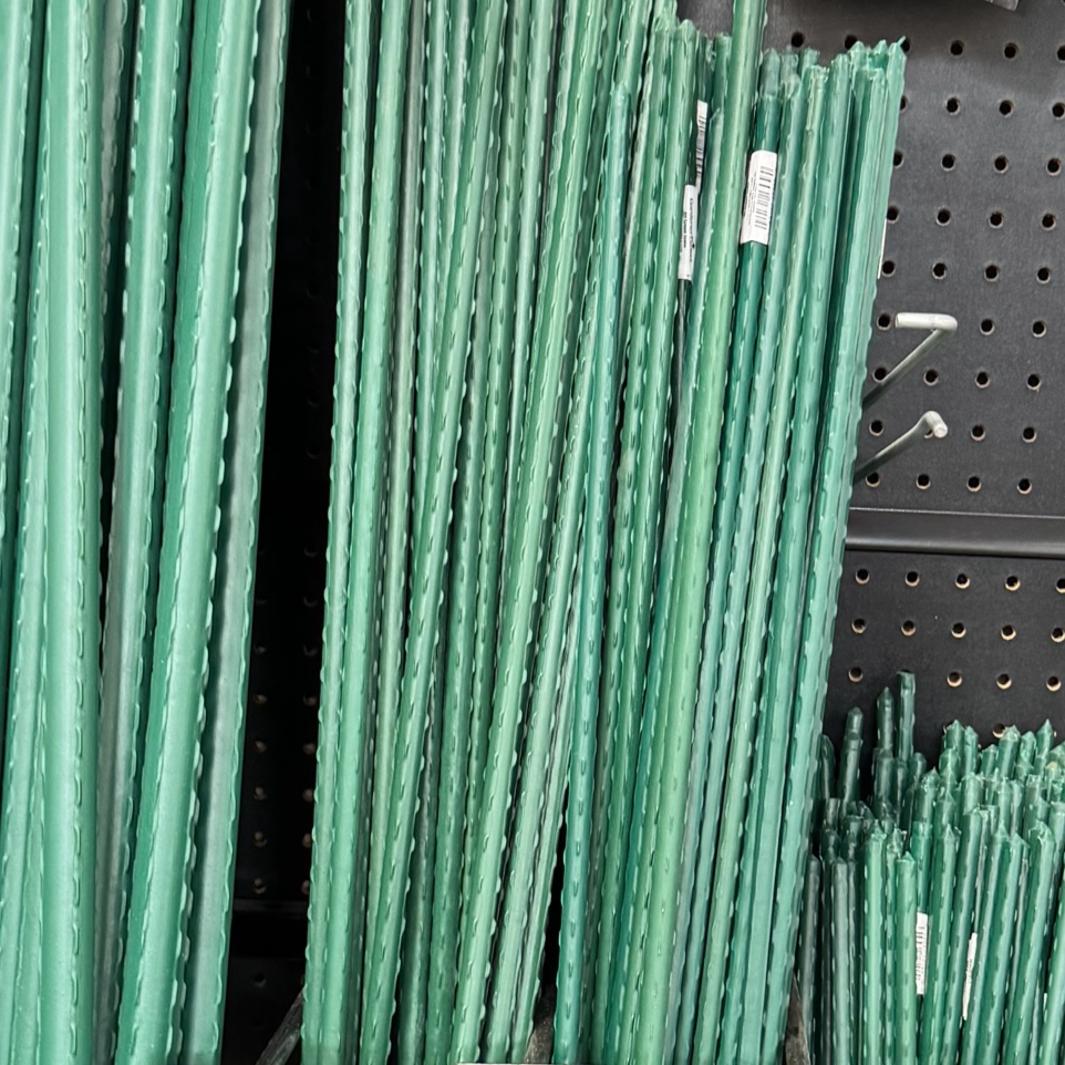 Green metal stakes on a black pegboard