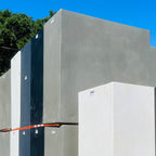 Stack of concrete blocks with a blue sky and trees in the background
