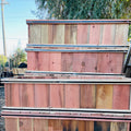 Stack of wooden planks with a natural wood finish outdoors