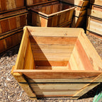 Wooden planter boxes stacked on a ground surface