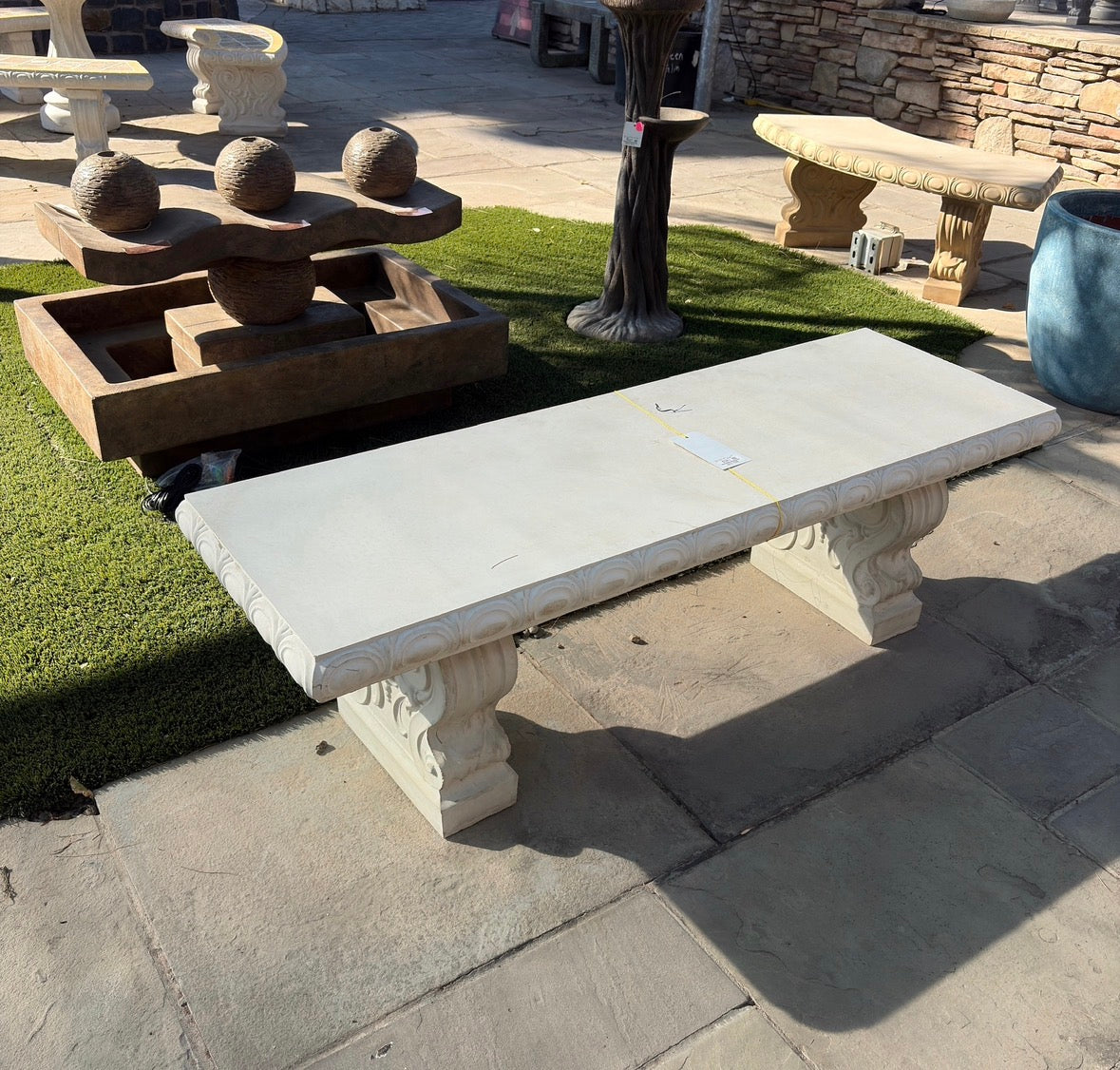 Ivory carved stone garden bench with ornate supports, actual product photo